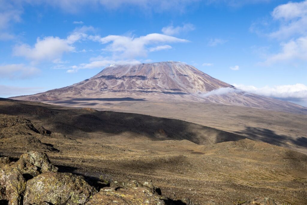 Breathtaking view of Mount Kilimanjaro under a clear blue sky, perfect for travel and adventure enthusiasts.